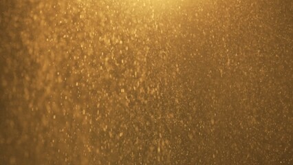 Many dust wooden particles floating in warm light on empty golden background with spotlight from above.