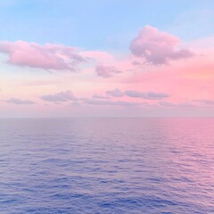 Fototapeta premium Serene Pastel Sunset Over Calm Ocean Waterscape