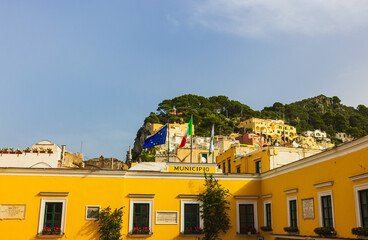 Enjoy a stunning view of a charming coastal village nestled against the high cliffs of Capri Island