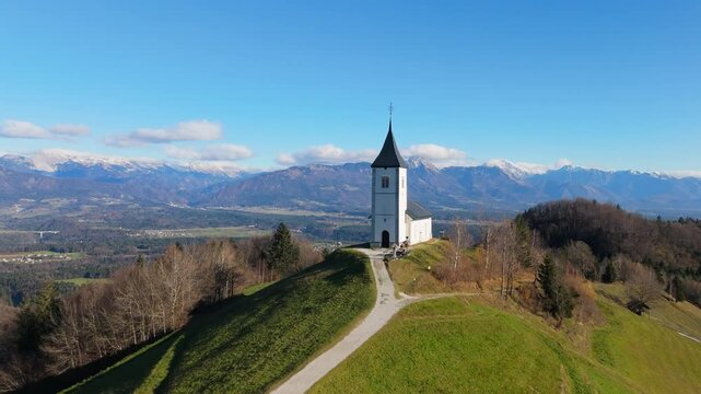 Saint Primoz and Felician, Jamnik, Slovenija / Slovenia, A hill top church in the mid day, late autumn, photogenic church, drone shot, aerial footage, amazing clip.