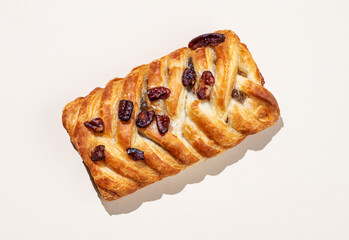 Fresh maple pecan bun on pink background with shadow. Creative layout and concept of healthy breakfast.
