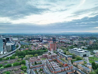 Fototapeta premium High Angle View of iconic Buildings at Central Greater Manchester City Centre and Tall Buildings During Golden Hour of Sunset over England UK. May 4th, 2024.