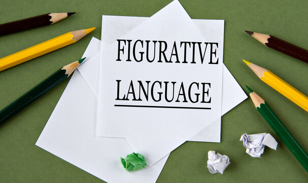 FIGURATIVE LANGUAGE - words on white paper on a green background with pencils