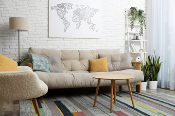 Stylish living room interior with comfortable sofa near white brick wall