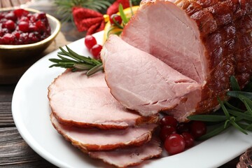 Christmas food. Tasty baked ham served on wooden table, closeup