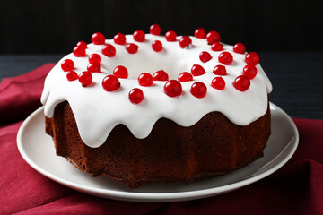 Tasty Christmas cake with red currants on table, closeup