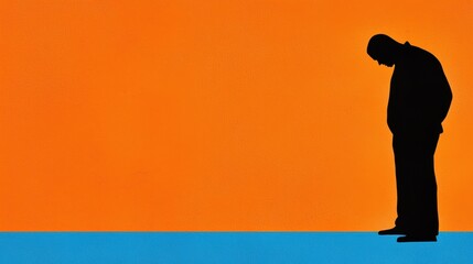 Obraz premium Silhouette of Man in Contemplation Against Vibrant Background