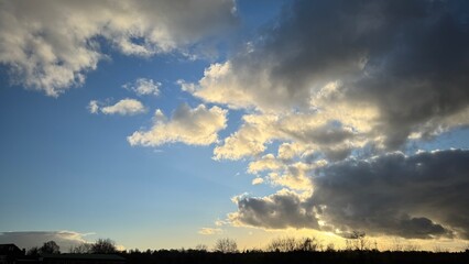 Sunset Sky with Cumulus and Stratus Clouds and Silhouetted Trees