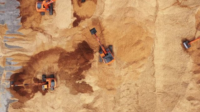 Aerial view road motor grader flatting dirt road surface, Motor grader road construction grader industrial machine construction site new road, Aerial view group excavator working on construction site.