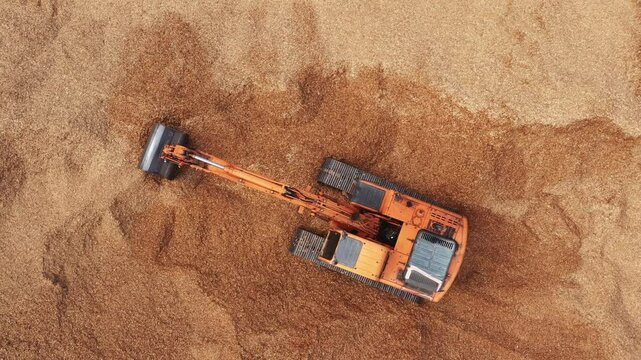 Aerial view road motor grader flatting dirt road surface, Motor grader road construction grader industrial machine construction site new road, Aerial view group excavator working on construction site.