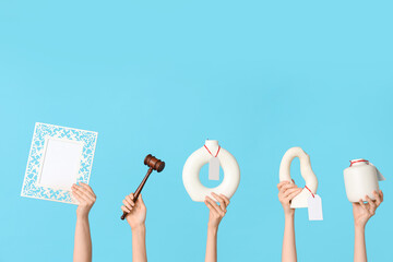 Female hands with auction gavel, antique vases and blank frame on blue background