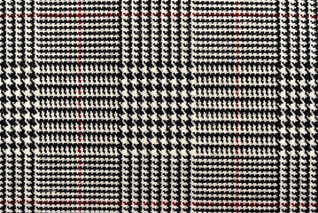 The texture of linen fabric in a large cell of black, blue and white. Scottish tailoring material. checkered fabric