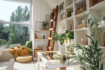 Shelving unit with books and coffee table in interior of living room