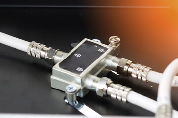 Metal F-connectors for connecting coaxial cable. Close-up. Soft focus.Sunflare. 
