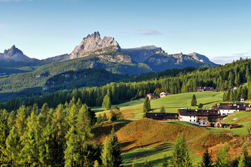 Mountain hut under steep mountains in the Italian Alps Dolomites, beautiful landscape