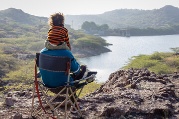Father and Son Bonding on Mountain Top with Lake View