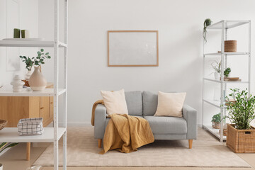 Shelving unit and grey sofa in living room
