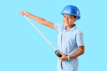 Cute little architect with measuring tape on blue background