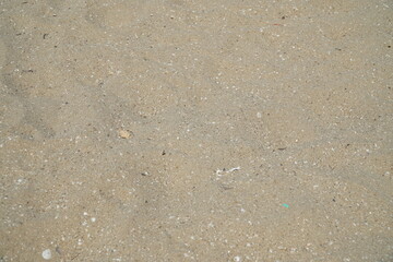 Beige Beach Sand with delicate textures and sun flare on surface, fine sandy beach at sunlight, minimal nature backdrop, calm concept, natural shore ocean or sea close up texture outdoor.
