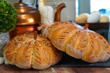 Baking pumpkin bread for family and friends for Thanksgiving dinner. An Autumn favorite, pumpkin shaped bread with decorative scoring complete with a cinnamon stick.