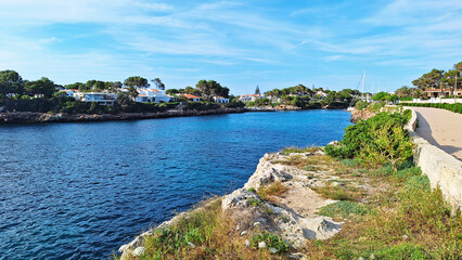 Seafront of the Ciutadella de Menorca, Balearic Islands, Spain. Entrance of the port with the Sa Farola Lighthouse on the opposite headland. 