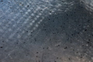 An abstract texture resembling matte metal, featuring overlapping black and white spots, creating a high-contrast, visually dynamic surface.