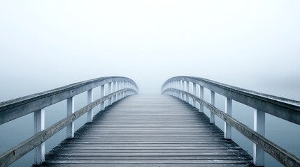 Obraz premium A wooden bridge extends into the mist.