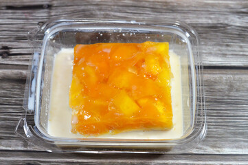 Pieces of fresh mango fruit on top of Tres leches cake, pan Tres leches, a sponge cake soaked in three kinds of milk, evaporated, condensed and whole milk, whipped cream, light cake with air bubbles
