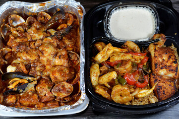 Assorted seafood cuisine of Mixed fish fillet, shrimps, squid, squid eggs, fish roe, mussels, clams and crabs with red sauce, herbs, red fish rice and Tahini salad, delicious meal of various seafood