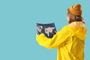 Young female sailor with map on blue background, back view. Woman in male profession concept