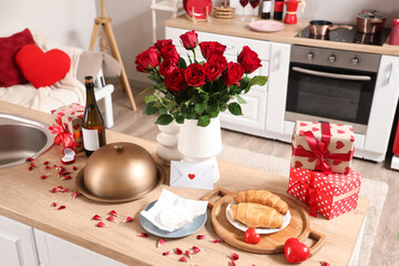 Vase with roses, cloche and presents on counter in kitchen decorated for Valentine's Day