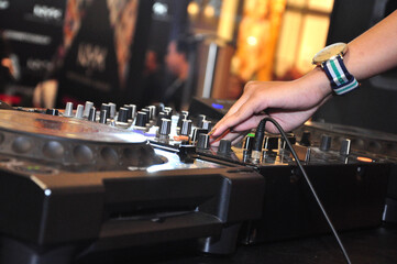 close up of disk jockey's hands and tools