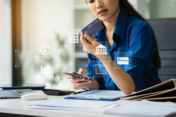 Female asian use credit cards to conduct financial transactions through phones, tablet at home...