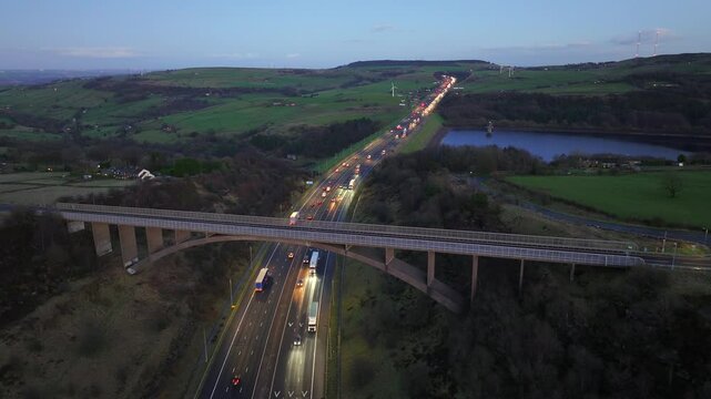 Aerial video of Scammonden bridge in Kirklees, west Yorkshire early evening showing the traffic and the countryside landscape. 