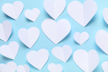 Composition with white paper hearts on color background. Valentine's Day celebration