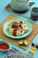 Siomay Bandung is an Indonesian steamed dumpling dish with fish, tofu, egg, potato, and cabbage, served with peanut sauce, sweet soy sauce, and lime