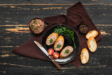 Plate with toasts, tasty pate, tomatoes, parsley and knife on dark wooden background