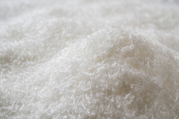 Heap of monosodium glutamate white crystals background. Pile of food additive MSG macro close-up. Concept of flavor enhancer E621 food ingredient.