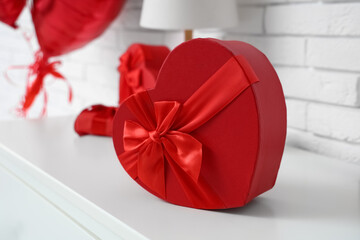 Gift box for Valentine's Day on commode in room, closeup