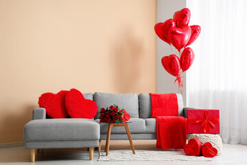 Interior of living room decorated for Valentine's Day with sofa, balloons and roses