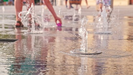 Happy Caucasian Kids Playing in City Square Piazza Pavement Flat Fountain Water Jets on Hot Summer Day