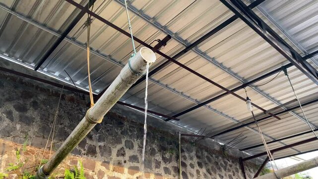 Water flow from plastic white pipe, under roof top