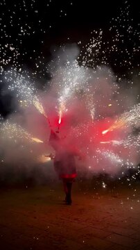 BARCELONA, SPAIN - 30 NOVEMBER 2024 : Crowds in the street for the fire run or correfoc, during festival, barcelona spain in vertical
