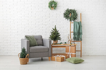 Interior of living room with armchair, Christmas trees and ladder