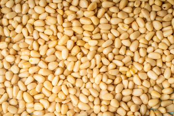 Background with pine nut texture. A lot of pine nuts, a view from above.