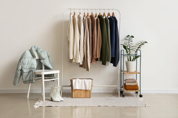 Interior of dressing room with rack, chair and winter clothes