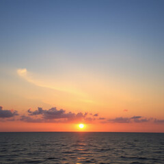 Fototapeta premium Scenic view of sea against sky during sunset