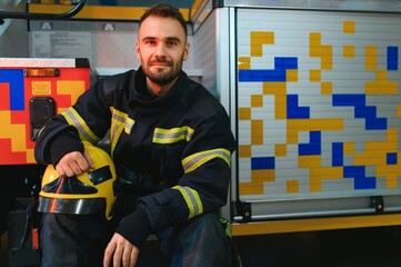 Portrait of male firefighter in uniform at fire station
