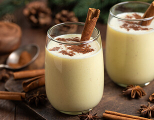 Two glasses of eggnog with cinnamon and anise