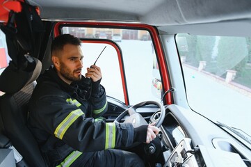 Obraz premium Firefighter drives a emergency vehicle with communication interior view